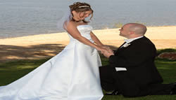 Groom kneeling with bride.