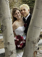 couple smiling in the forest.